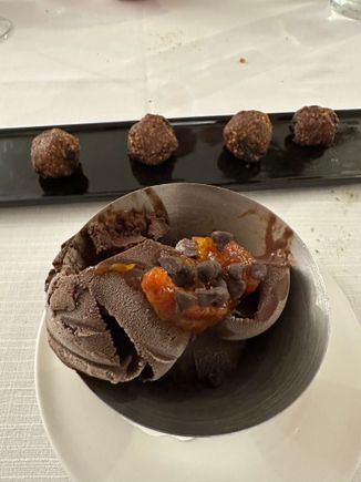 Chocolate gelato with bits of fruit rind and, in back,  
biscotto Cogliesse, made from ground almonds, sour am arena jam, and cinammon (not very sweet)