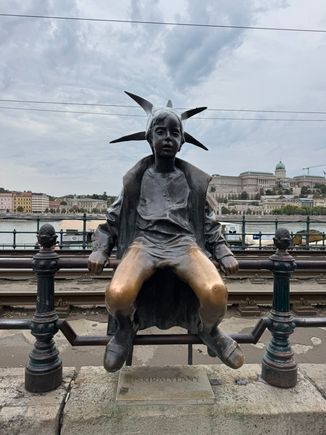 The Little Princess statue on the Danube promenade - the artist was inspired by his eldest daughter who enjoyed playing dress-up - wearing a princess costume and a crown made out of newspaper