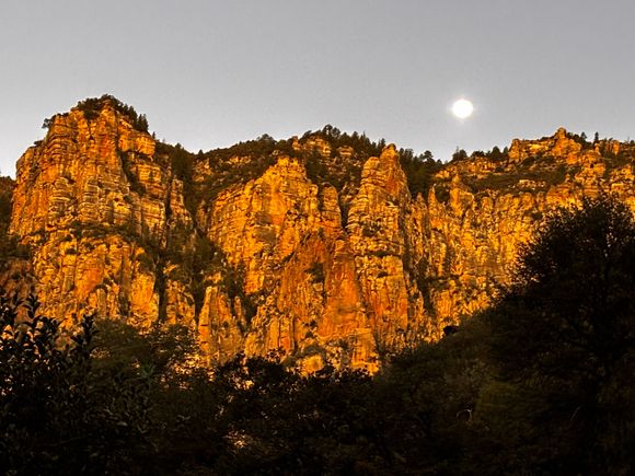 Super moon setting this morning, shot from our front porch