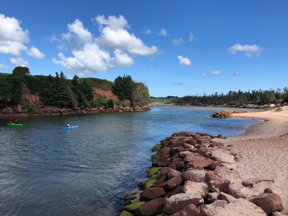 This view is part of the channel and a pond where people are kayaking.