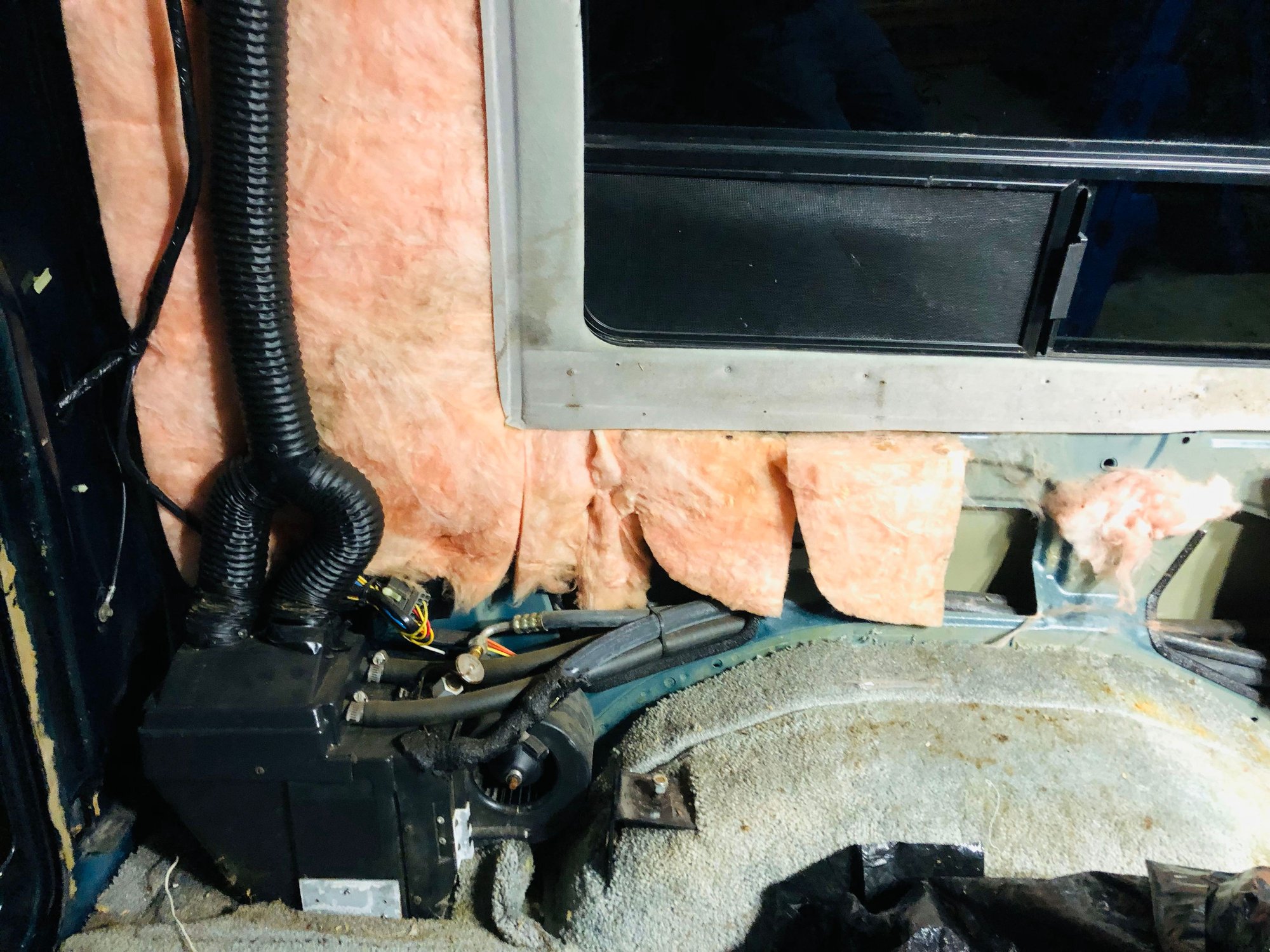 Behind wall panel exposing more of rear HVAC