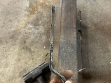 So I set this up on the table in preparation for decreasing in paint. Next, I wanted to modify the bracket that holds the alternator and also on top it held the air pump that was locked up, which I’m not going to put back on. And I didn’t want a big old chunk of metal just sticking up and because I’m still doing this as cheap as possible I decided to cut it up and then grinding edges and then prep it for paint turned out pretty good. I’m happy enough with it. Here’s the chunk that I cut off.