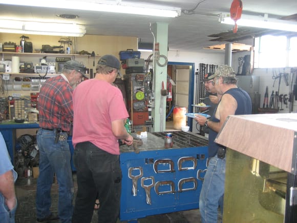 Everyone bellied up to Don's continuing welding/fab bench. The conversation was paused for some serious eating. Left to right
Don, Craig, Jim, and Chris.