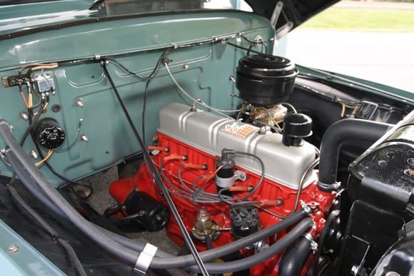 a 54 6 cylinder engine with a black air cleaner.
