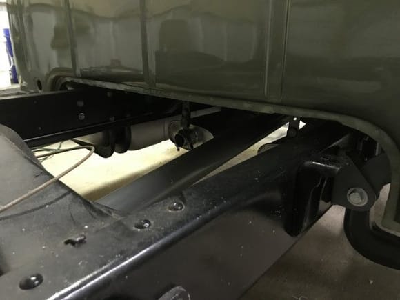 Sorry, it's kind of dark, but the new bolt in the lower right is the lower cab mount bolt. There is one on each side of the cab that needs to come out.