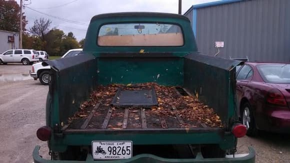 Rear with 55 f100 tailgate on what I can only guess is a piece of plywood used as the bed liner.