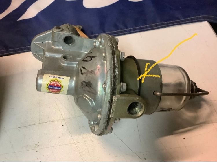 Fuel pump with arrow pointing where the piece goes.