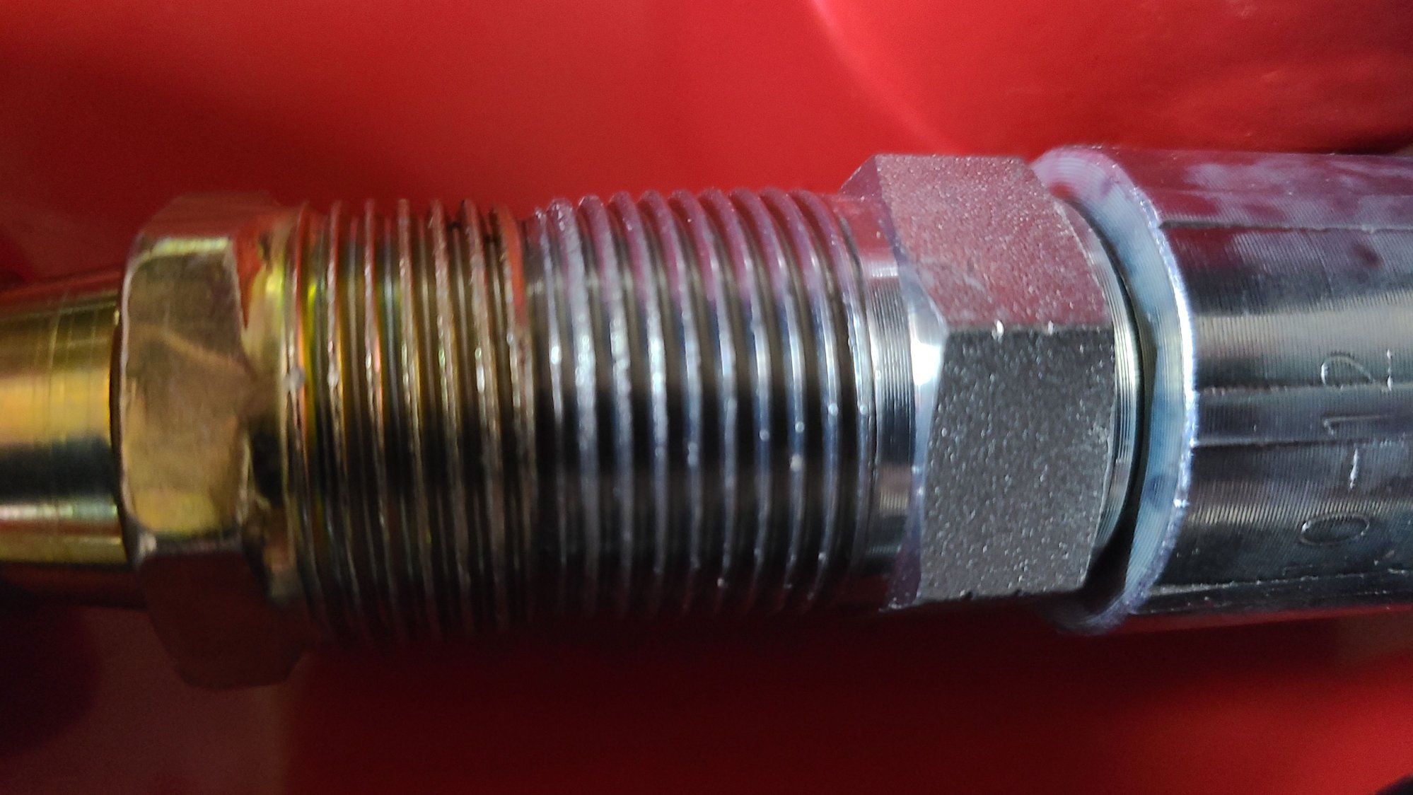 The anodized fitting is provided and believed to be an M22. The silver fitting is 3/4 inch pipe.