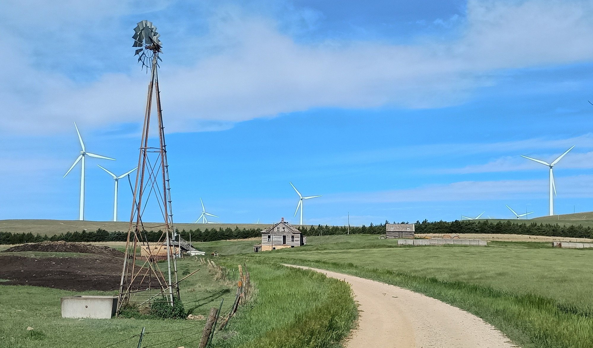 Beautiful old windmill in same picture of some of the green new eyesores.