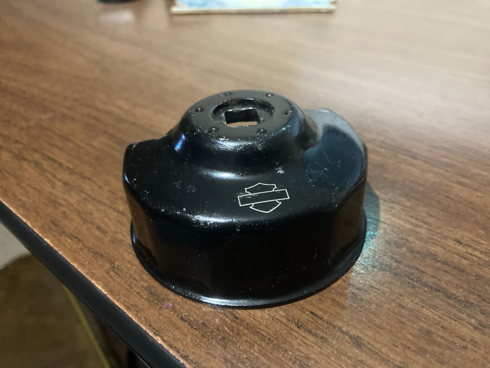 Quit messing around with those strap things, just pick up Harleys Oil filter removal tool and be done with it.