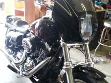 I picked up this HD 1/4 faring off Craig'slist for 200 with the brackets. It mounted up with the stock headlight visor. The wind break is a welcome change on the freeway