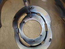 Cowbell fastened to adapters, with attaching screws captured. The hex is visible in the drilled holes.