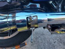 To slide the cone out of the way, you have to be able to lift the chrome shield high enough to slide the pipe clamp,  seen just to the right of the cone on the bottom of the cover, forward out of the way. 