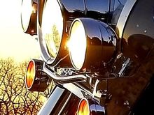 Visor type on headlight as well as wider straighter with small lip all around on spot lights.