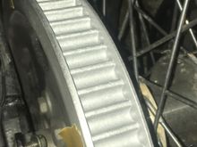 A photo of the sprocket, where 50 % of the chrome was gone, so I painted it with chrome primer and several layers of extra hard paint. Not as good as a new wheel, which was incredibly expensive, but better than before, which was really bad with sharp chrome flakes on it.