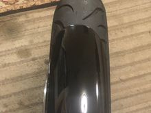 I went with the new 120/70/21 Avon cobra chrome. It is very low profile. Sometimes with this mode you have to adjust or get a wider fender . This is my stock fender. I think it will be fine.