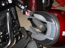 Lock with helmet attached at D-rings.  I have it rolled so you can see the lock and D-rings.  In practice, helmet sits on to of footrest.