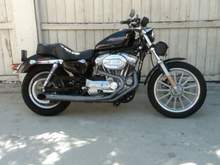 2007 XL883. I added an RB Racing 2 into 1 exhaust, and a Screaming Eagle high flow intake. I changed the Transmission pulley to a 30 tooth unit so at 80 mhp, the RPMs are at about 4,000. I added a Tachometer, as well as a Sundowner seat, and a padded, passenger backrest bar from Harley Davidson. I added Ricor Intimidators in the front fork tubes, and heavier fork oil. I picked the fork bag at Sturgis, South Dakota. 