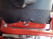 seat off showing tab that mounts to T-bar with single nut and washer