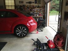 Generator repositioned with the exhaust facing out, close the garage door to the top of generator if no power and raining.