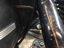 Throttle cables turn down and stays on the same side of the frame, do not cross to the left side above or below the neck, you will pinch the cable.