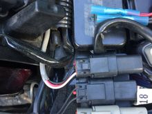 A pic I grabbed last week, working on something else...  But, these are the three connectors for the rear lights (turn/run/brake) looking from the right side of the bike.  The battery, then gas tank would be to the right.