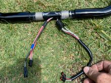 All 4 harnesses go to right side, it looks like the plug on the far left is the heated grip connector 