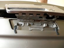 hooked in the back, held up to expose latch