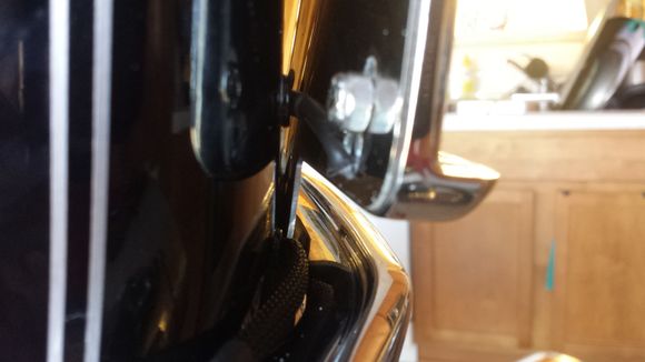 Many people may do this differently. I decided to drill a hole behind the frame and use a plastic hole plug (same as what they use behind the turn signal bar) in order to run my wires through the fender. I thought this was a much cleaner look.