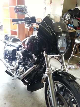 I picked up this HD 1/4 faring off Craig'slist for 200 with the brackets. It mounted up with the stock headlight visor. The wind break is a welcome change on the freeway