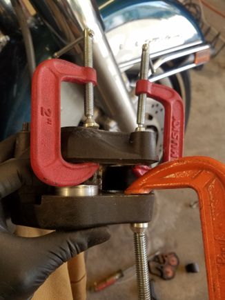 I used some c-clamps to hold 3 pistons in then pumped the brake lever until the fourth was about 1/2" out. Any farther and you risk them popping out completely which is a whole new can of worms.