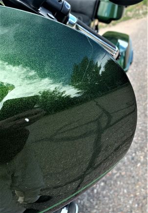 Left edge of fairing. A couple of fractures in the paint on the right and left upper edges.