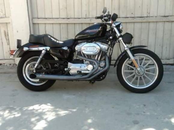 2007 XL883. I added an RB Racing 2 into 1 exhaust, and a Screaming Eagle high flow intake. I changed the Transmission pulley to a 30 tooth unit so at 80 mhp, the RPMs are at about 4,000. I added a Tachometer, as well as a Sundowner seat, and a padded, passenger backrest bar from Harley Davidson. I added Ricor Intimidators in the front fork tubes, and heavier fork oil. I picked the fork bag at Sturgis, South Dakota. 