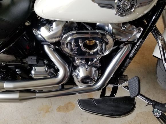 Hoses running down between rockers and then along from to the swingarm.