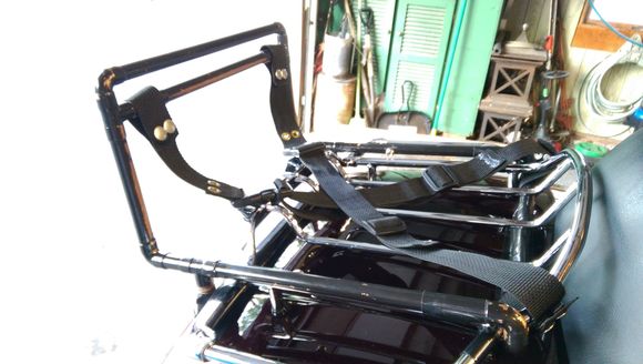 The whole thing is made from copper tubing, reinforced inside on the two bottom corners with some JB Weld inside; all of the straps snap on and off (the cross strap isn't on there yet, but you can see where the snaps are.  The whole thing weighs maybe two pounds, tops.