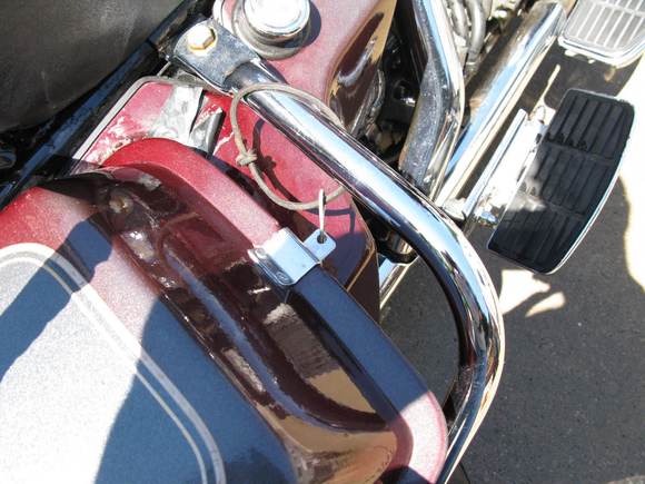 i drilled a hole in the tab and put a hair pin thru it to hold the lid on if i forget to lock the cover. a piece of leather shoe lace keep the pin from being lost.