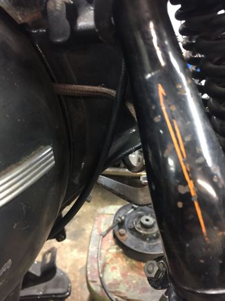 Throttle cables turn down and stays on the same side of the frame, do not cross to the left side above or below the neck, you will pinch the cable.