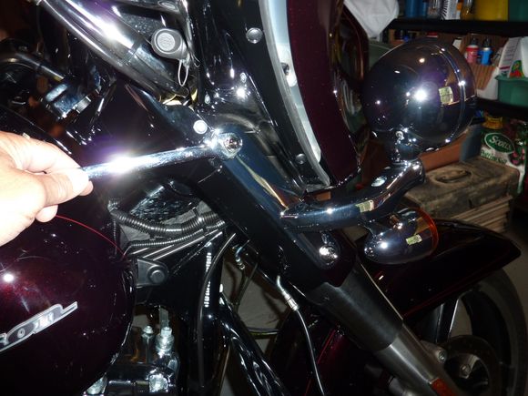 Remove the two castle nuts that fasten the lamp brackets to the fork legs.