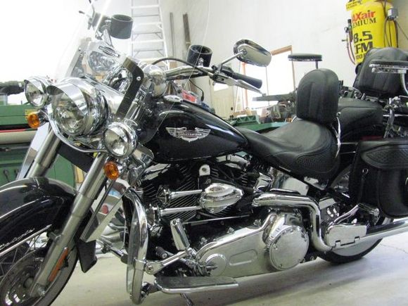 Adjustable passenger peg on this side needed some help from a machinist friend because of the dual exhaust, put on an air horn like the look and it's loud, ordered some armrests and fabricated brackets to make them work, adjustable plexi in engine guard, headlight visors, fork mounted wind deflectors.