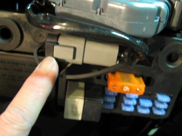Locate Data Port connector on fuse panel. Slide connector to the left to remove from panel, then pull off rubber boot to expose connector.