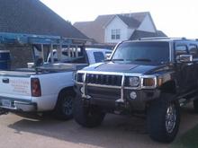 Monster H3 beside work truck