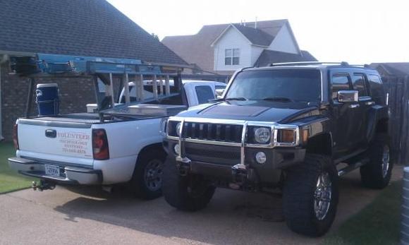 Monster H3 beside work truck