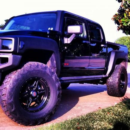Blacked out! I have bedlined the fenders and vinyl wrapped the grill but before you freak out know that I plastidiped the fenders first before the bedliner.  It is removable back to factory.
