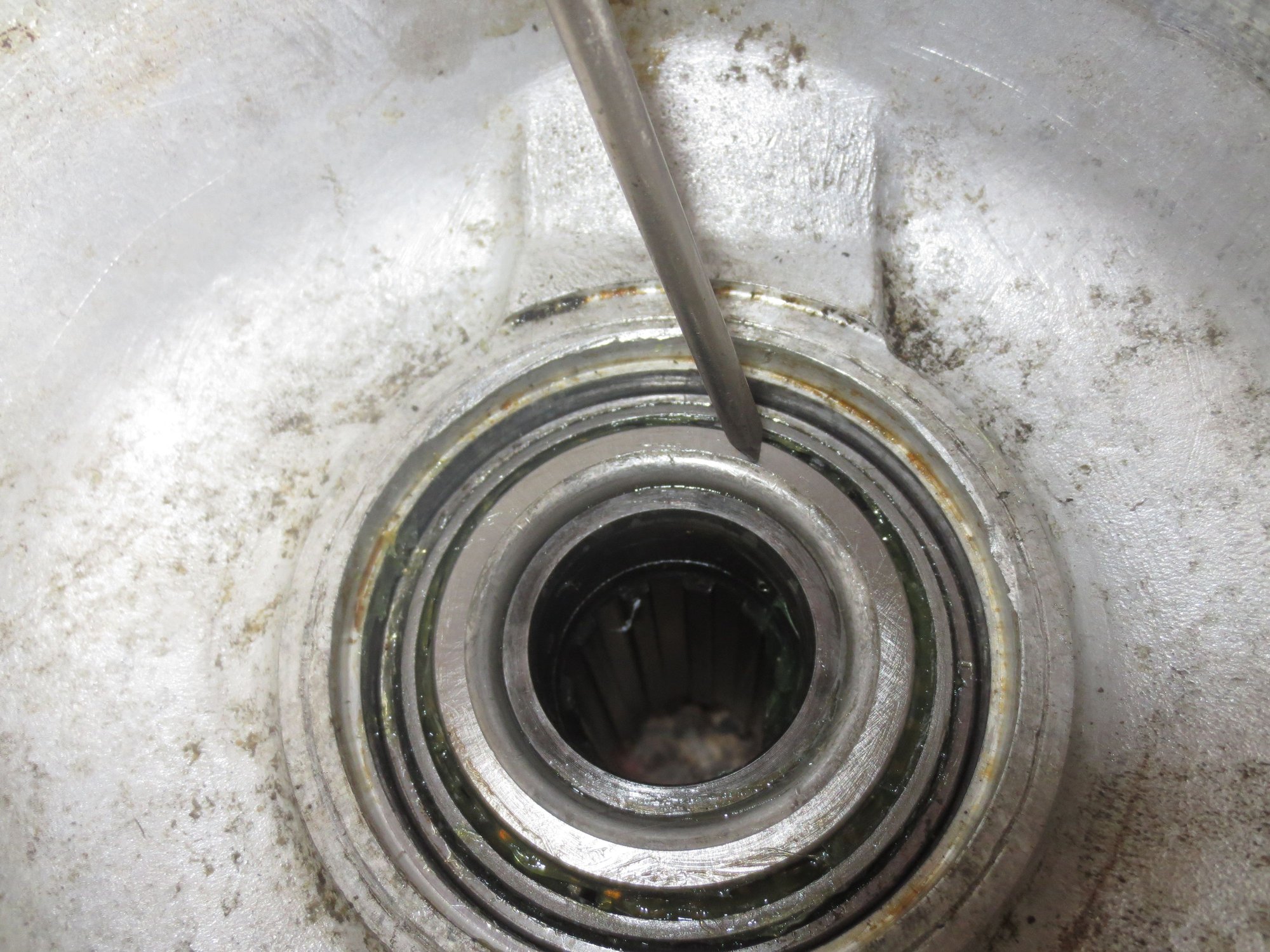 Bearing fully drifted into place. It is the space bewteen the bearing (pointer on it) and the hub tube (inside the bearing below it) that the spacer is requied for