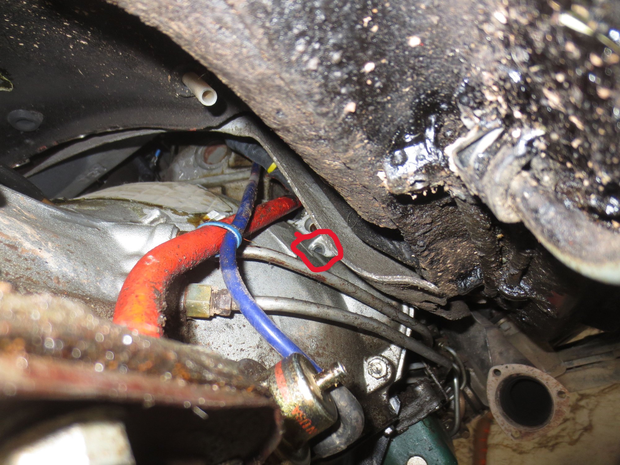 This is a shot of the installation in the car. The red ring shows the top starter bolt hole, the bolt has been removed in this shot. NOTE to get even this amount of access, the gearbox has to be lowered as explained below.