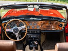 This was the interior of my 73 Triumph. People used to joke with me that it was a little Jaguar-ish with the leather seat covers, Burled walnut dash, door caps, and matching wood rimmed wheel!
