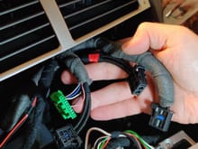 The video plug that is part of the wiring loom with the green connector is the one that goes into the "Head Unit Replacement" component provided by the Seller (see pic below):
