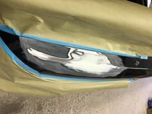 Sanded back to bare metal and lightly skim coated with filler.  Under that is a light layer of lead filler to fill in some of the more obvious gouges in the metal.  Dave uses both: lead to get the surface to where it needs to be, and poly as a skim coat for fine contouring.