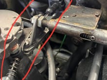 


Here is the TV Cable at the throttle, note the copper washers (in red circle), that’s where the ball stud mounts on the bottom side of the throttle disc, the ball stud attaches to the end of the cable with the black plastic clip (barely visible) 



