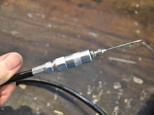 Needle threaded onto grease gun hose